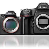 Black Nikon and Sony DSLR camera bodies with attached lens mounts and control dials