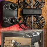 Drone remote controller with prop guards and included accessories packaging