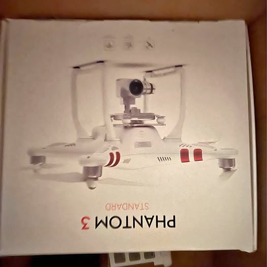 DJI Phantom 3 quadcopter drone with mounted camera and red accents