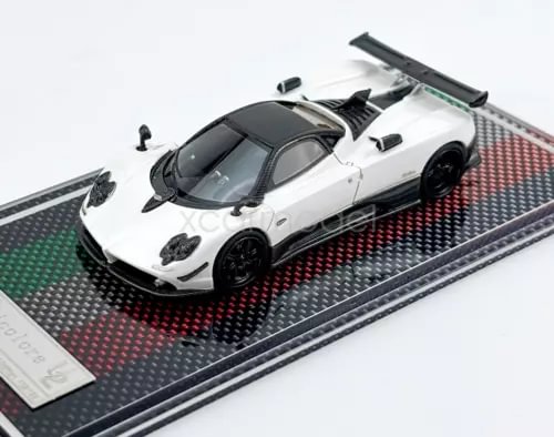 White racing sports diecast model car with black wheels and hood vents, on base