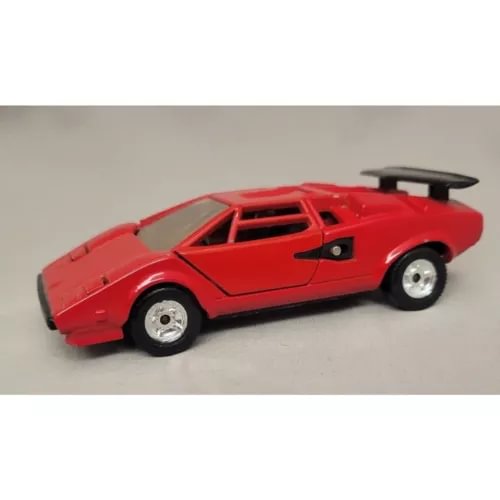 Red 1:43 diecast sports car model with black hood and rear spoiler