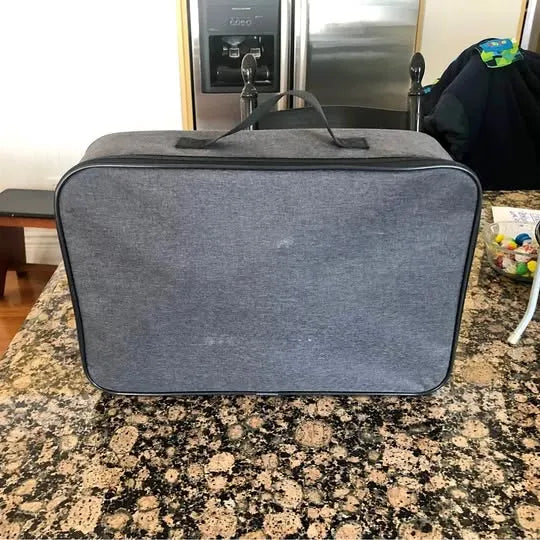 Gray fabric drone carry case with top handle and zipper trim