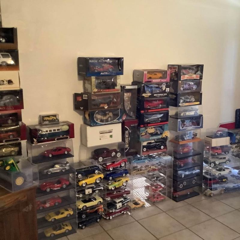 Boxed 1:18 diecast model cars on wall shelves, assorted colors