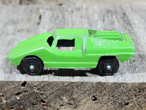 Green vintage diecast car with black wheels, side profile
