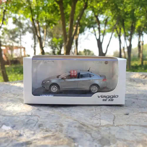 Gray diecast car model in retail display box with clear window