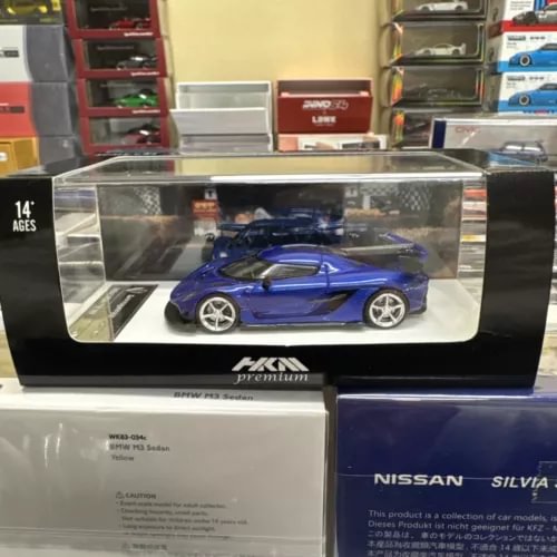 HKM 1:64 Koenigsegg Jesko diecast car, blue with black accents, in clear display box