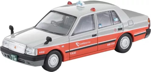 Diecast taxi sedan model car in white with orange side stripes