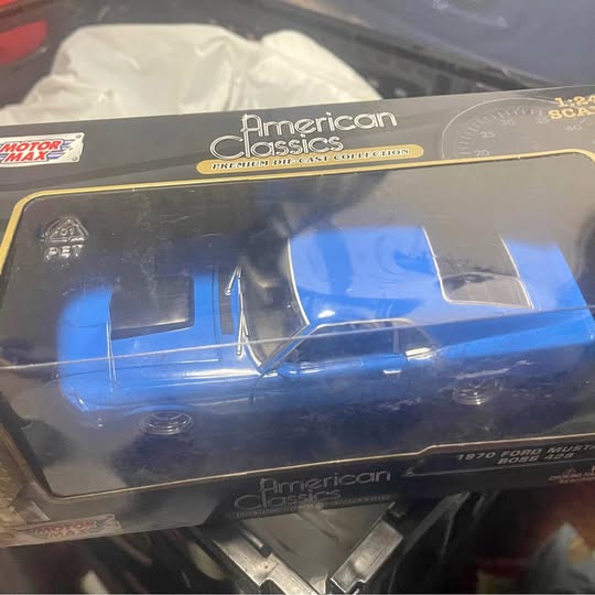 Blue diecast 1970 muscle car model with black base and American Classics branding