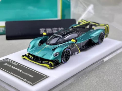 1:64 scale diecast racing car, teal with black and neon yellow accents