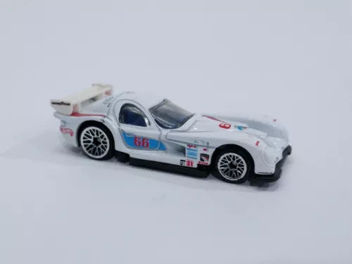 White die-cast race car with blue and red decals, hood open, front-left view