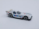 White die-cast race car with blue and red decals, hood open, front-left view