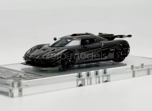 Diecast racing sports car model in dark gray/black with detailed body and wheels