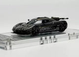 Diecast racing sports car model in dark gray/black with detailed body and wheels