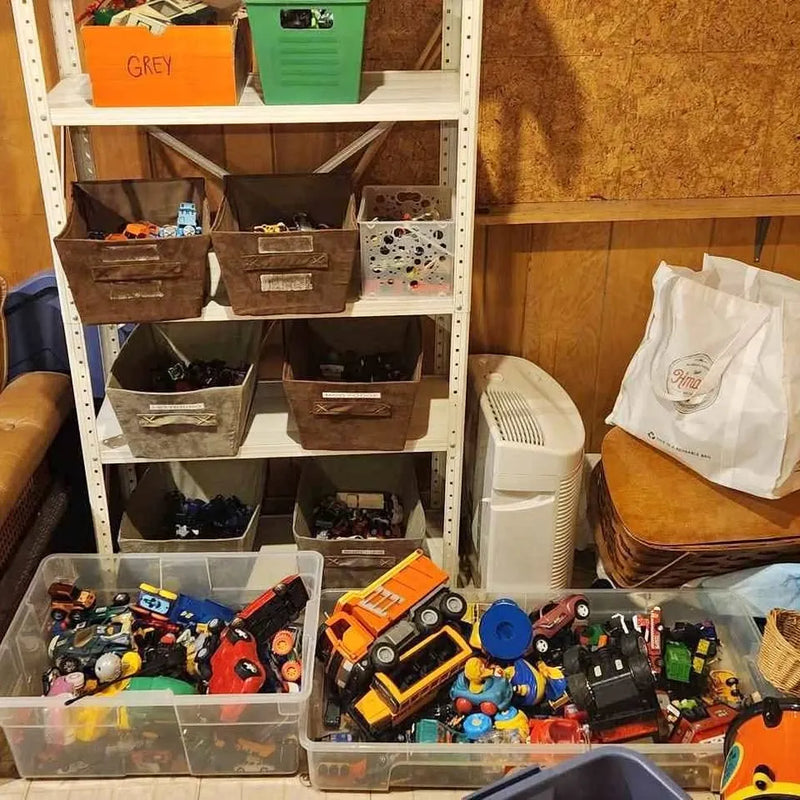Diecast toy car lot in clear bins, mixed trucks and vehicles with colorful details