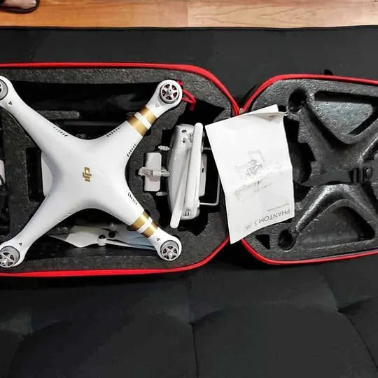 White quadcopter drone with gold details in red foam storage case