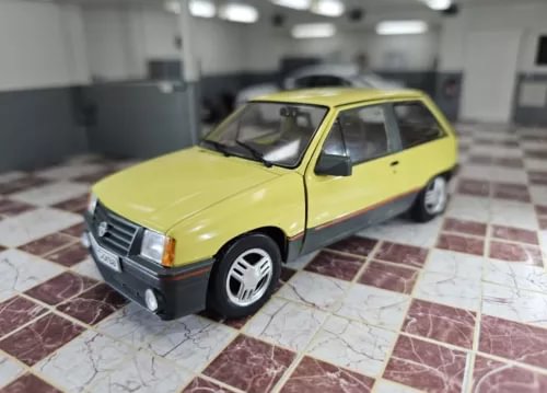 1/24 scale diecast model car, yellow with black bumper and wheels