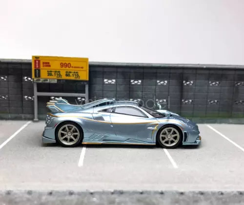 1:64 blue diecast sports car model with silver detailing, side view