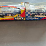 Diecast racing car set in packaging, two blue cars with #31 on the boxes