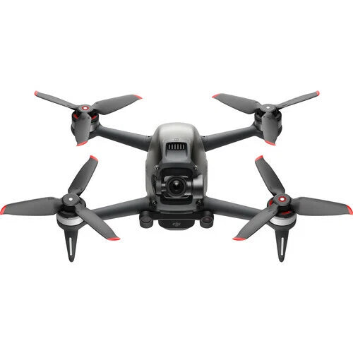 FPV quadcopter drone with front camera, red-tipped propellers, dark body