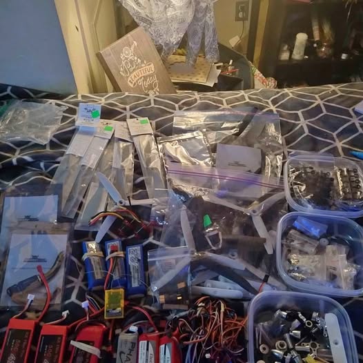 Assorted drone and RC parts, including circuit boards, wires, and small components