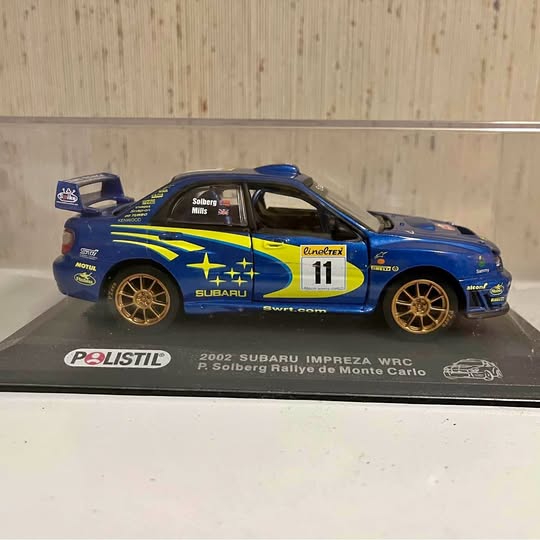 WRX diecast rally car, blue with yellow livery and #11 on the door