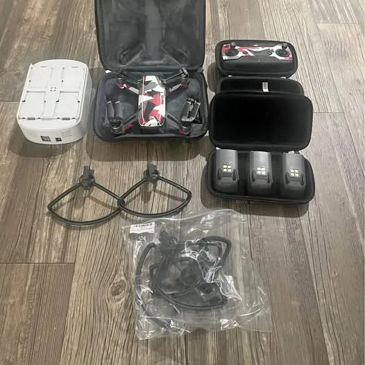 Drone accessories bundle with open hard case, propellers, batteries and charger