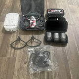 Drone accessories bundle with open hard case, propellers, batteries and charger