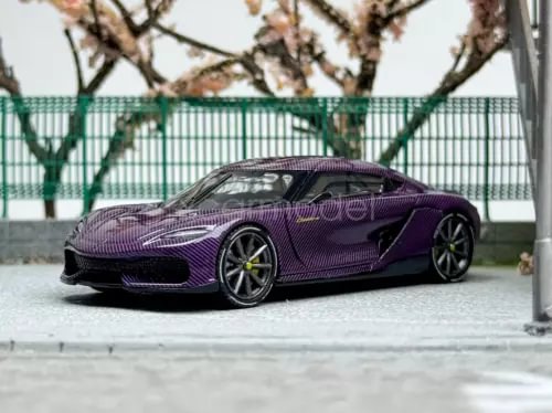 Purple diecast sports car model with black wheels and carbon-fiber look