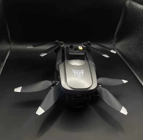 Foldable gray quadcopter drone with camera module and four propellers