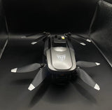 Foldable gray quadcopter drone with camera module and four propellers