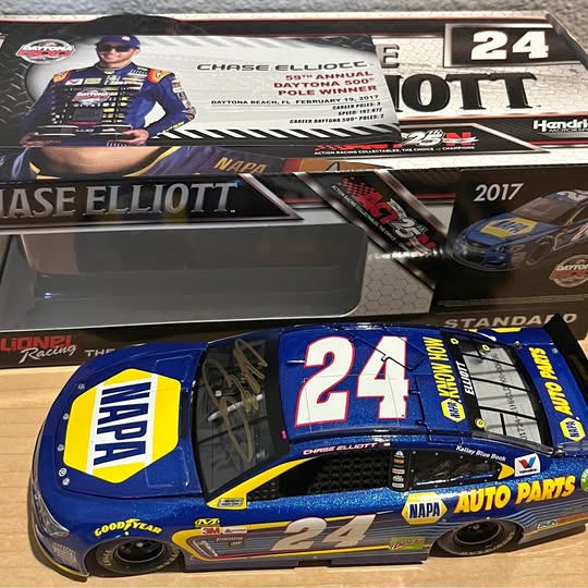 24 NASCAR diecast race car model with blue yellow graphics and black rear spoiler