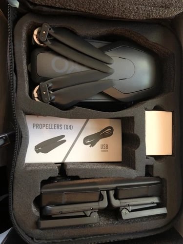 Drone kit in case: foldable drone, four propellers, USB cable and battery