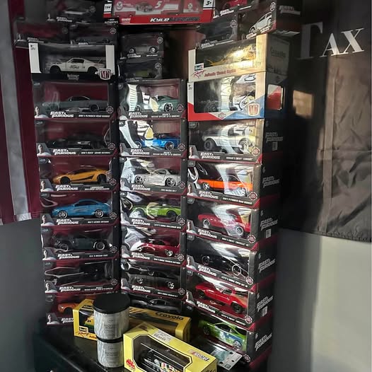 Die-cast cars in retail boxes on a display shelf