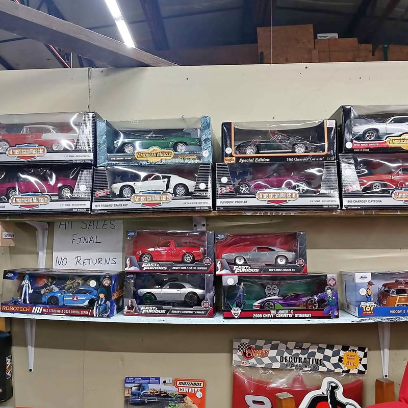 1:18 scale diecast car display in boxes, assorted vehicle colors