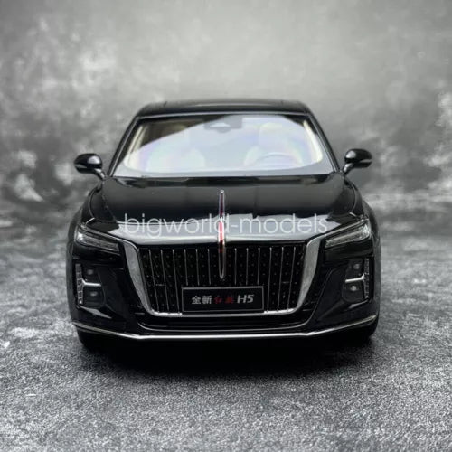 Black diecast car model with front grille and headlights, 1:18 scale, front view.