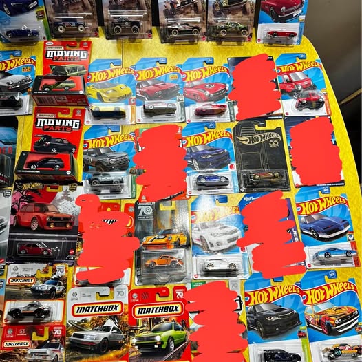 Assorted diecast toy cars in Hot Wheels and Matchbox blister packs