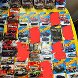 Assorted diecast toy cars in Hot Wheels and Matchbox blister packs
