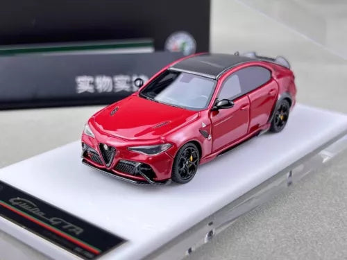 Red sports car model diecast resin, front three-quarter view, black wheels and grille