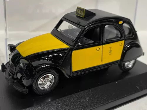 Yellow and black diecast taxi model car with TAXI roof sign, front-left view