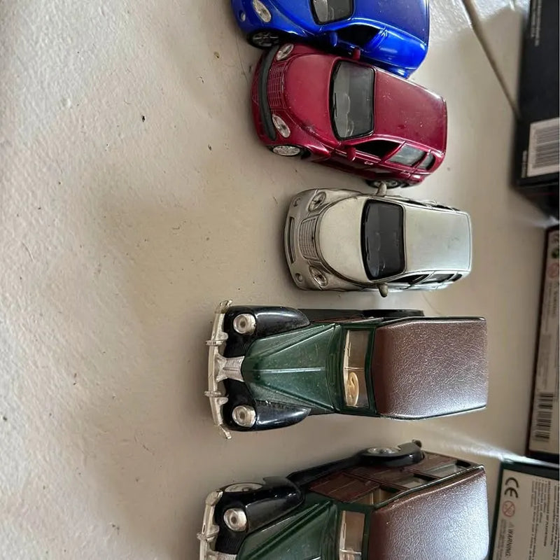 Diecast toy cars and trucks, blue red white green with black accents