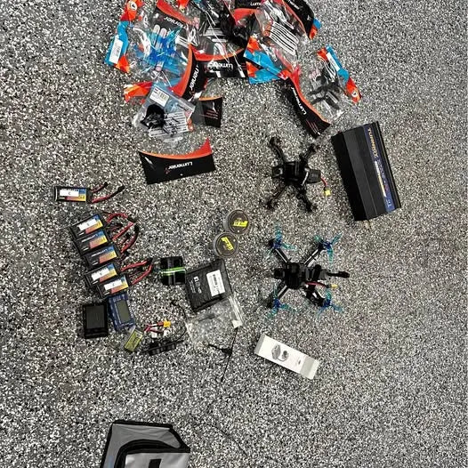 FPV drone bundle with quadcopter frames, motors, and battery packs laid out