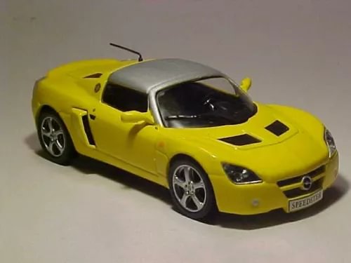 Yellow diecast sports car model with silver hood and black windows, front 3/4 view