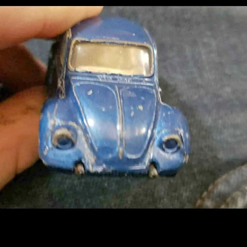 Baby blue die-cast classic Volkswagen Beetle toy car, front view with round headlights