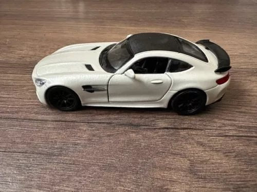 1:43 scale diecast sports car model, white body with black roof and accents