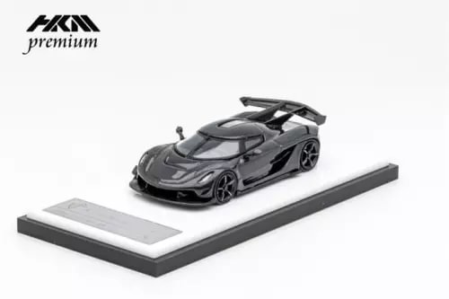 Black full-carbon diecast model car on display base, 1:64 scale