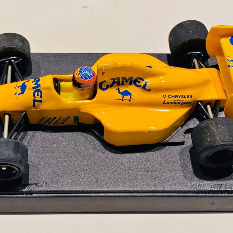 Yellow diecast race car model with open cockpit and black tires