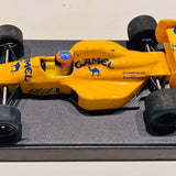 Yellow diecast race car model with open cockpit and black tires