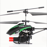 Small RC helicopter drone with green-and-black fuselage, main rotor and tail boom
