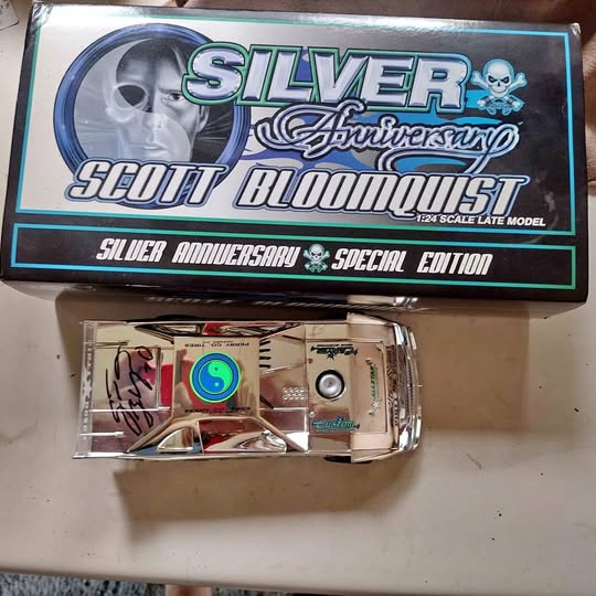 Silver-toned diecast car in clear blister tray inside collectible retail box.