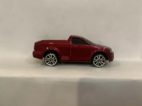Red diecast pickup truck toy with silver wheels and racing decals